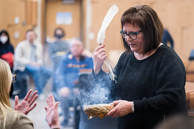 Rebecca Richards, tribal chair for the Pokagon Band of Potawatomi Indians, performs a smudging ceremony to begin a meeting with Michigan Law students and members of the Pokagon Band tribal court in Dowagiac, Michigan.