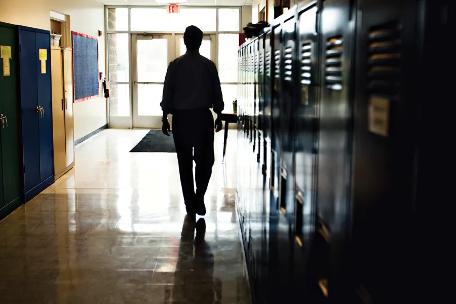 A person walking down the hallway in a school