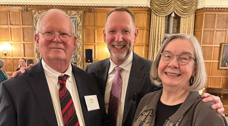 Faculty gathered in March for a pandemic-delayed celebration of Bruce Frier and Christine Whitman’s retirements. They are pictured at the dinner with Dean Mark West (center).