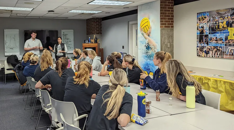 Student-attorneys Andrew Watson, ’23, and Emily Gaudiani make their presentation to the water polo team.