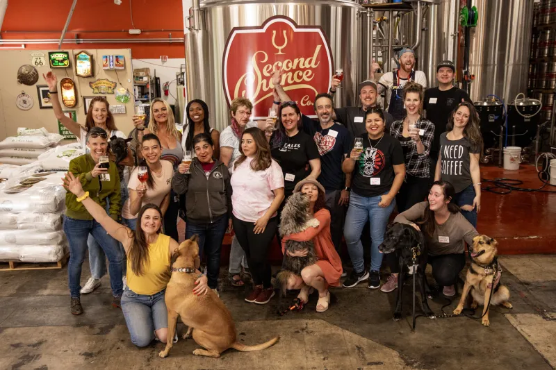 Staff of brewing company that promotes rescuing dogs