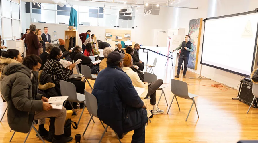 Student speaking in front of a group of people.