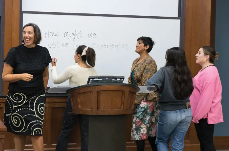 Professor Bridgette Carr teaching students in a classroom.