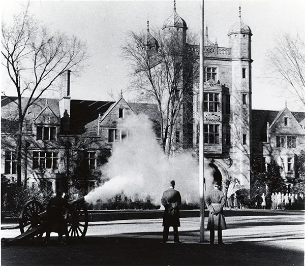 Soldiers fire a cannon in front of the Lawyers Club.