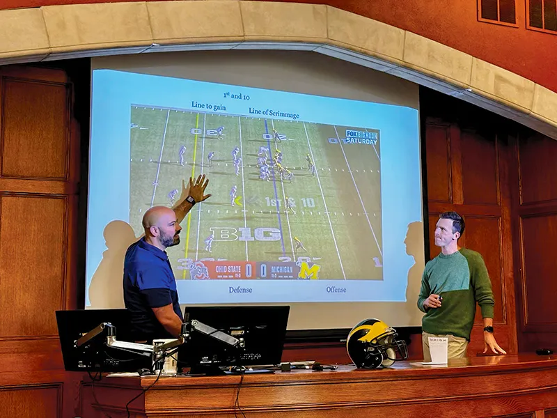 Assistant Dean Ramji Kaul, ’05, and 1L Jordan Barpal teaching an American Football 101 class for international students.