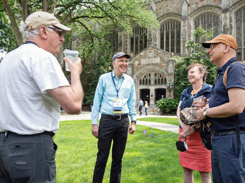 Alumni Laughing and conversing on the Law Quad during a Michigan Law School Reunion 