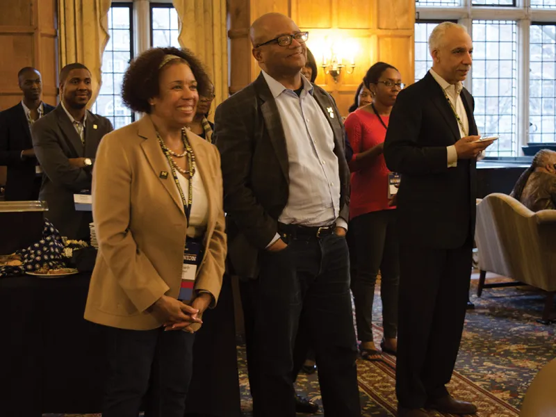 Reunion executive chairs Elizabeth Campbell, ’78, and Saul Green, ’72, stand with Broderick Johnson, ’83, (center), during welcoming remarks on Friday. 
