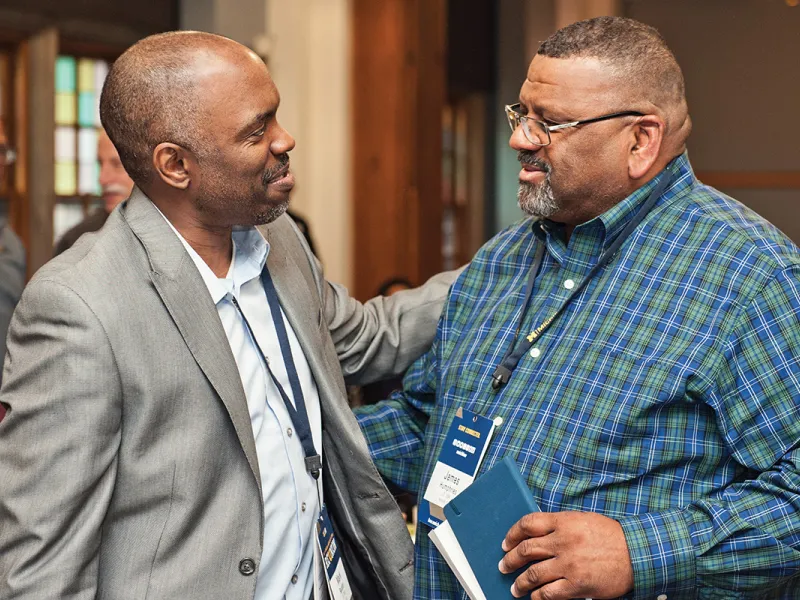 The Hon. Mark Randon, ’92, (left) catches up with fellow alum James Humphries, ’84.