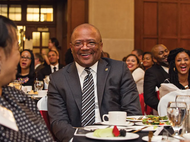 Broderick Johnson, ’83, laughs while being introduced as the keynote speaker at the Alden J. “Butch” Carpenter Gala.