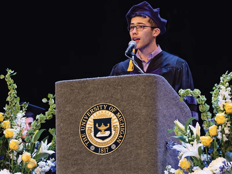Person speaking at the podium at graduation