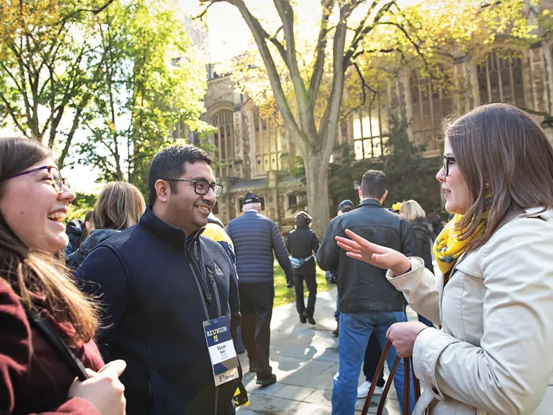 Varun Behl, ’13, catches up with fellow alumnae while tailgating on the Quad.