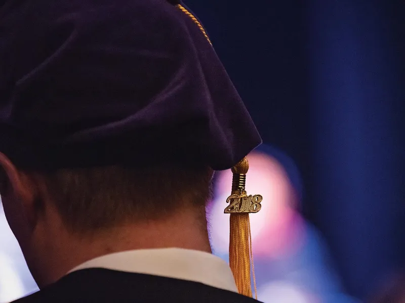 Close up picture of a Michigan law school graduation tassel
