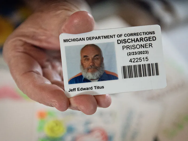 Jeff Titus shows a Michigan Department of Corrections ID card that identifies him as a discharged prisoner.