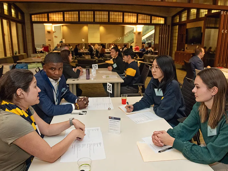 Group of students meeting at a table.