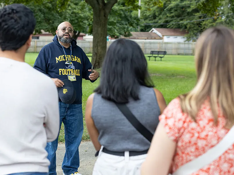 A person speaking in front of a group.