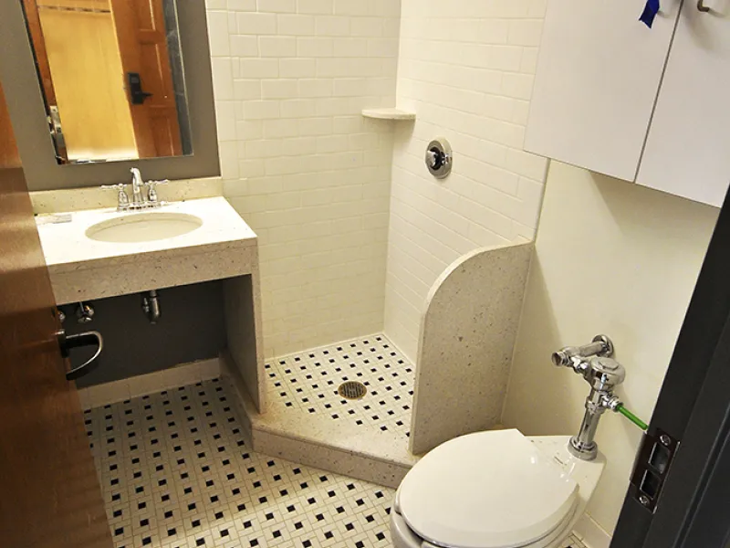 Tile gleams in a newly renovated bathroom in the Lawyers Club.