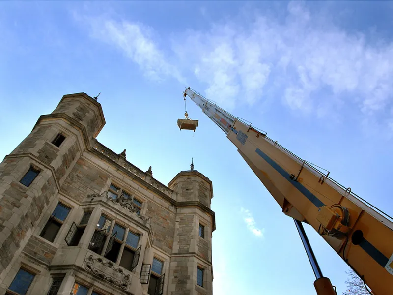 A construction crane looms over the tower of the Lawyers Club.