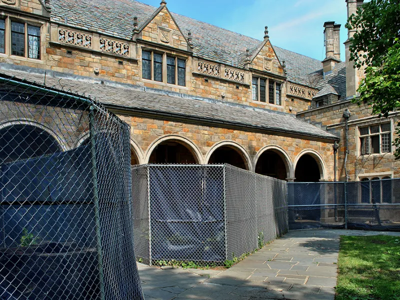 Fencing blocks the covered walkway in the interior courtyard of the Lawyers Club.