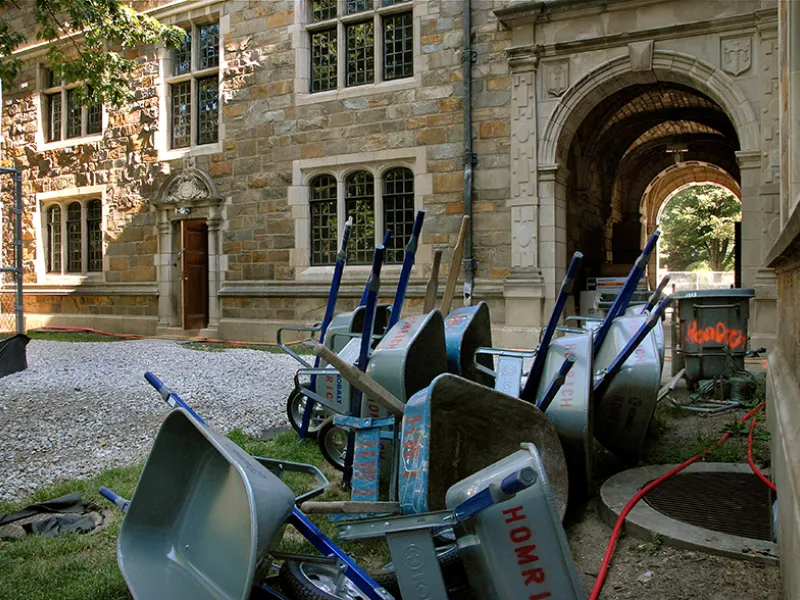 A dozen wheelbarrows lay nested on their sides along one wall of the Lawyers Club.