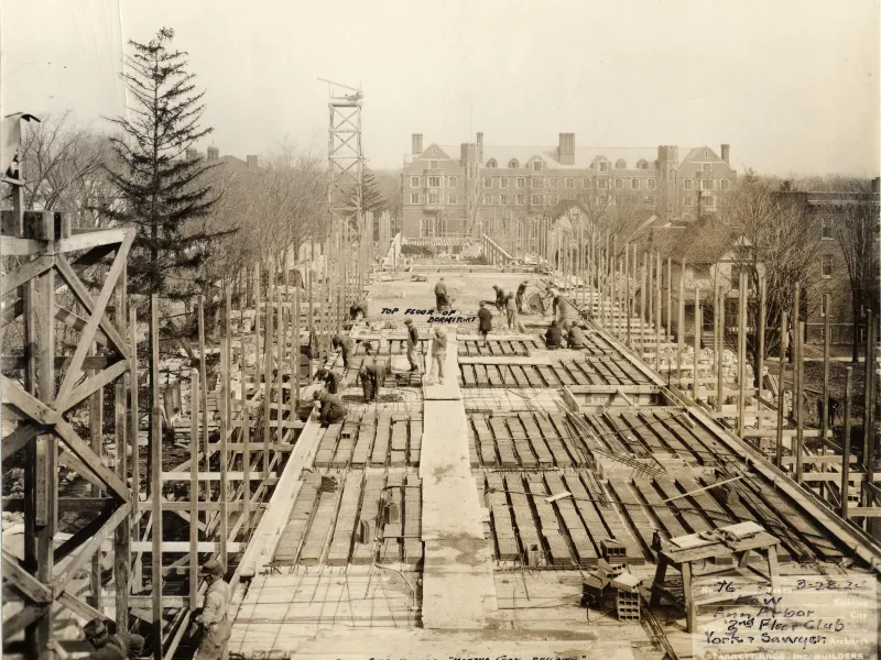 Wooden planks line the foundation of the Law Quad buildings under construction.