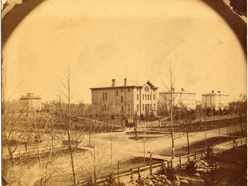 In 1859, the three buildings of the Michigan Law School rise above the surrounding countryside.