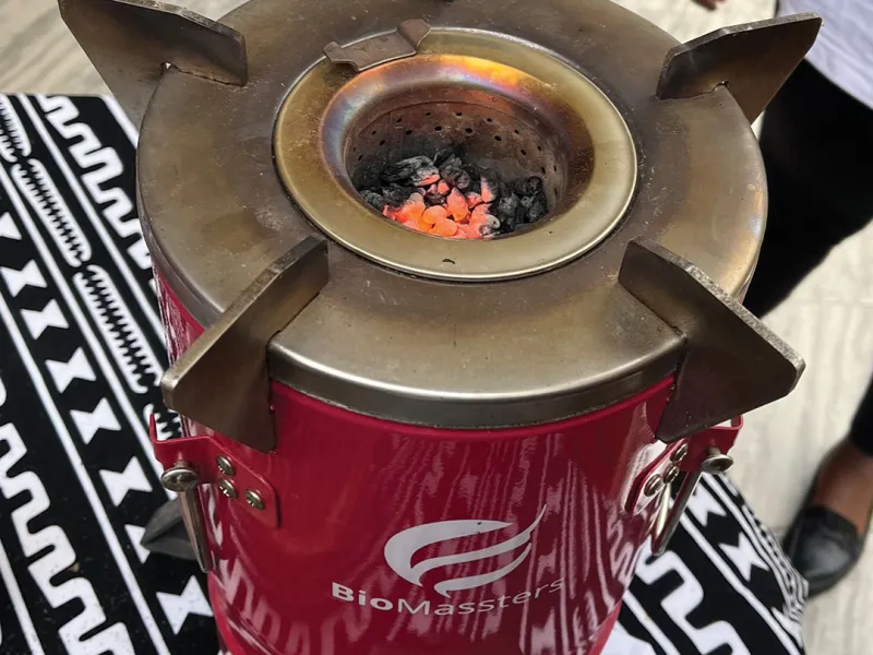 Clinic student Lindsey Corbett checks out BioMassters stoves in a storehouse in Kigali. The company produces inexpensive clean-cooking stoves as well as pellet fuel from recycled products for use in the stoves