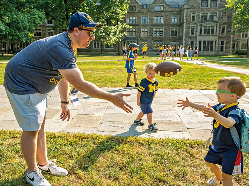 Michigan Law alumni and their children gather in the Law Quad for an alumni reunion.