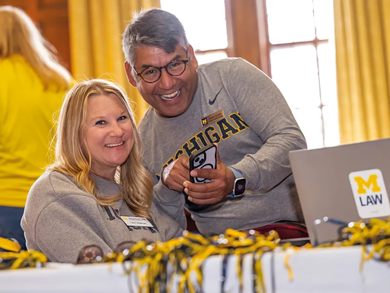 Michigan Law alumni gather in the Lawyer's Club lounge for an alumni reunion.