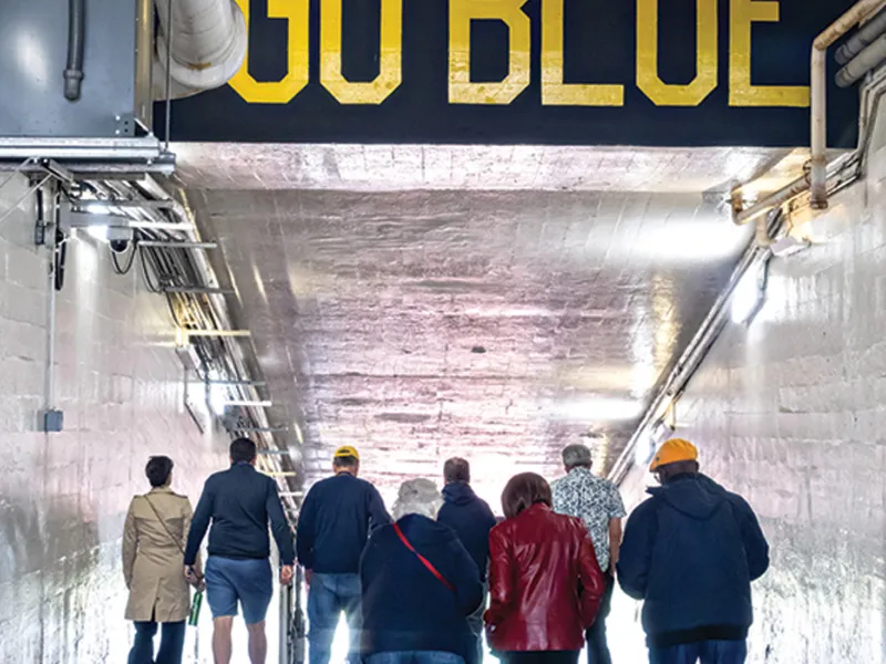 Michigan Law alumni walk through the Michigan Stadium tunnel