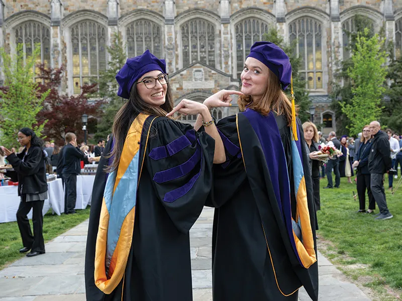 Michigan Law students pose and point to their shoulders.