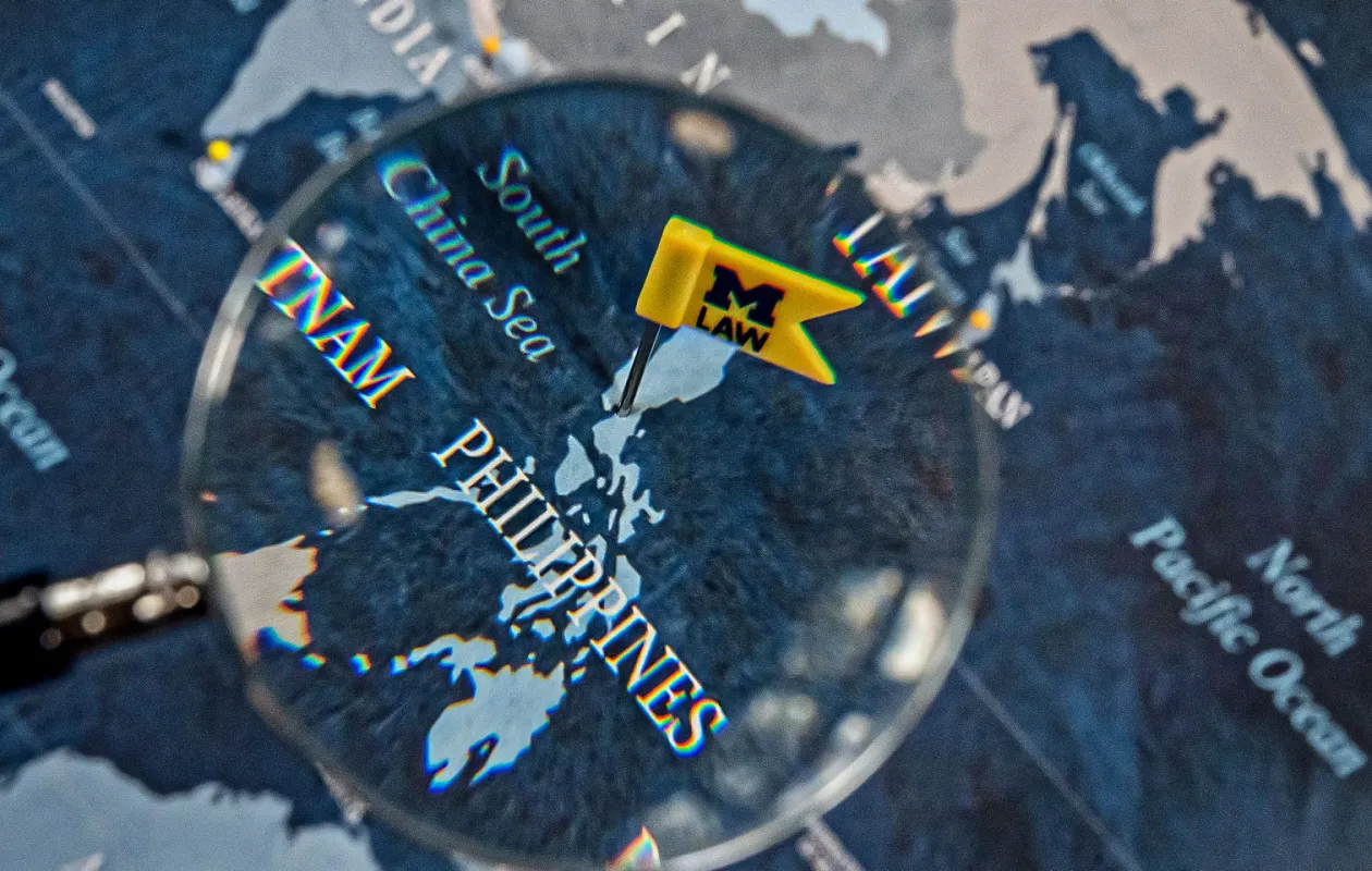 A map with a magnifying glass on the Philippines.