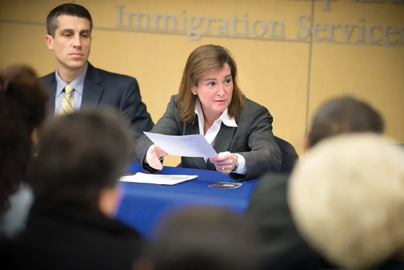 Barbara McQuade speaking in a conference room with meeting attendees