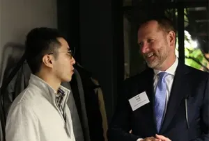 Two men having a conversation at an event