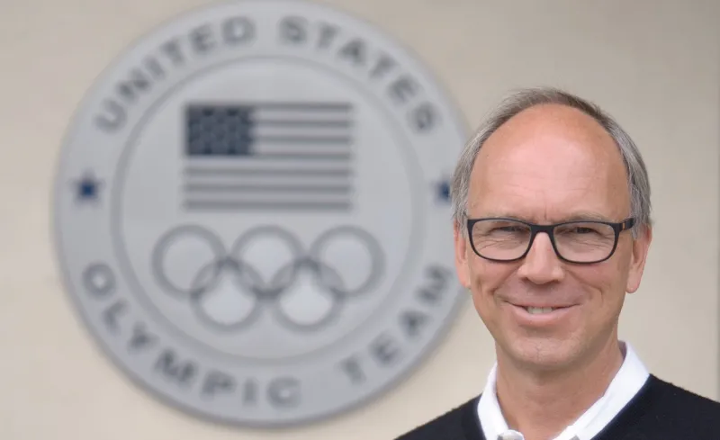 Chris McCleary in front of Olympic rings