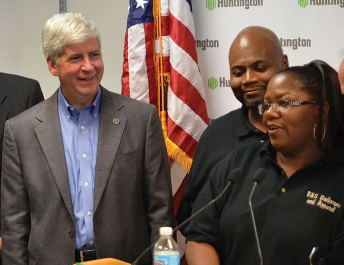Gov. Rick Snyder helps launch a new micro-lending program during an event in Detroit. Below: Gov. Snyder and Emergency Manager Kevyn Orr address reporters during  a news conference in Detroit.
