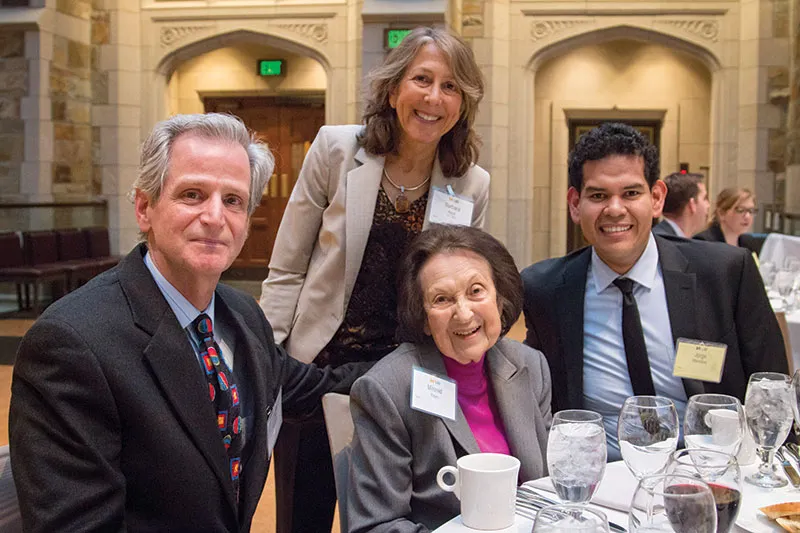 Adelman Scholarship recipients sitting around a table at a celebratory event Adelman Scholarship recipients