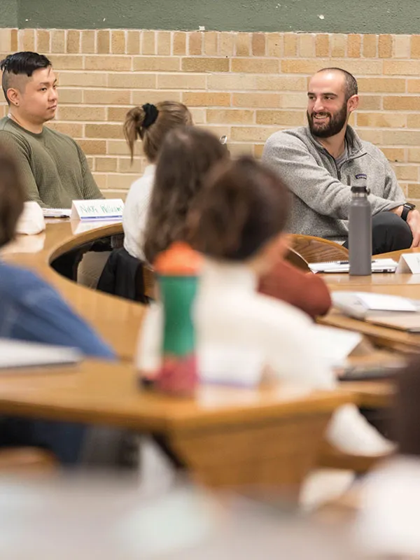 Michigan Law students talking in a classroom.