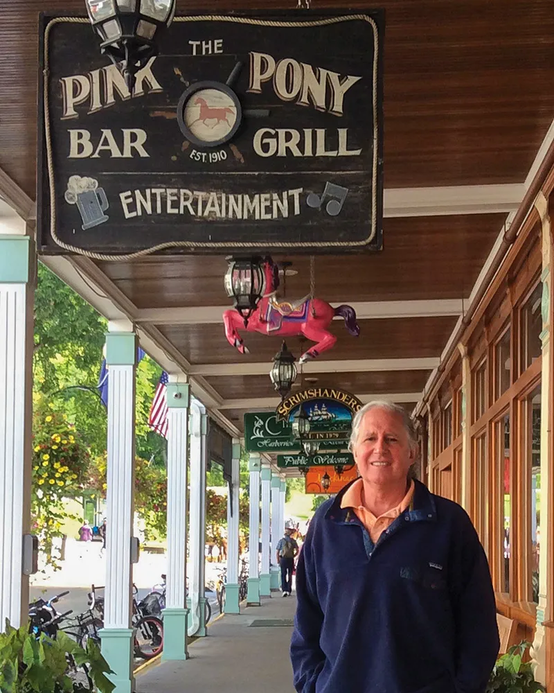 R. Charles McLravy II, ’77, in front of the Pink Pony on Mackinac Island.