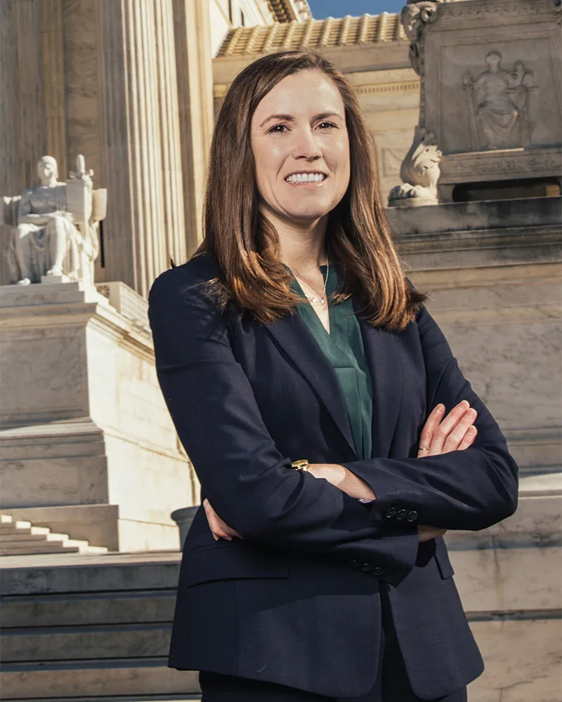 summer-2025-cover-feature-aside-004.jpg A woman in business attire standing with her arms crossed.