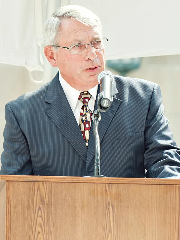 Bruce Bickner, ’68, speaks at the dedication ceremony for South Hall (now Jeffries Hall) in 2012.