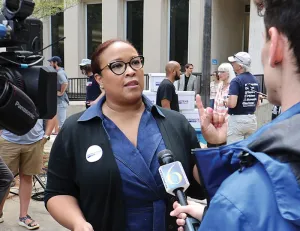 Khalilah Spencer, ’01, speaks with reporters.