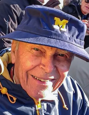 A portrait of The Hon. William “Bill” A. Clark, ’52 at a Michigan Football game.