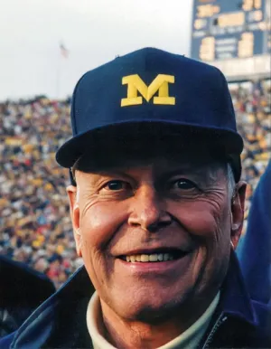 A portrait of The Hon. William “Bill” A. Clark, ’52 at a Michigan Football game.