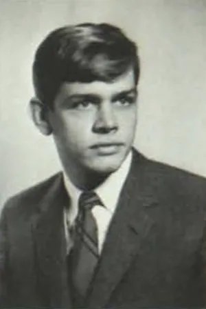 A young man in a suit poses for a University of Michigan student photo.