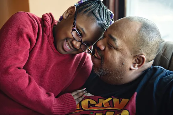 Young girl hugging her father