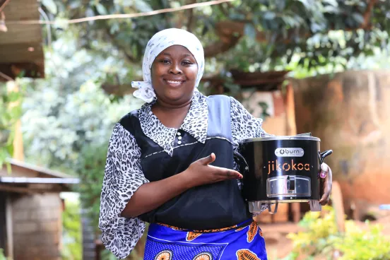 Women holding a clean cooking stove by BURN Manufacturing