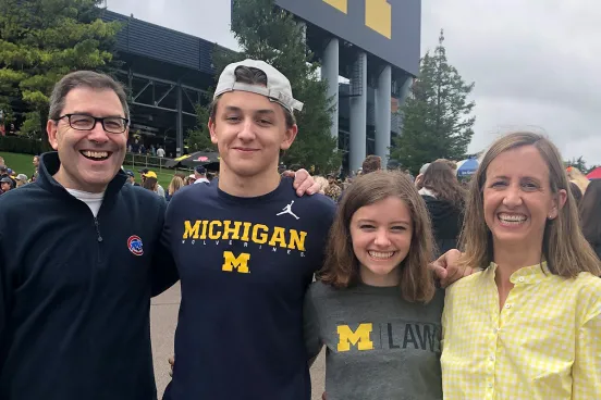 Lacey Sikora and family standing outside the stadium 