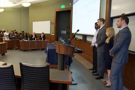 Students standing in the front of a class at a University Law School Event 