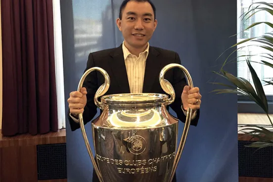  Li poses with the Union of European Football Associations’ championship trophy.