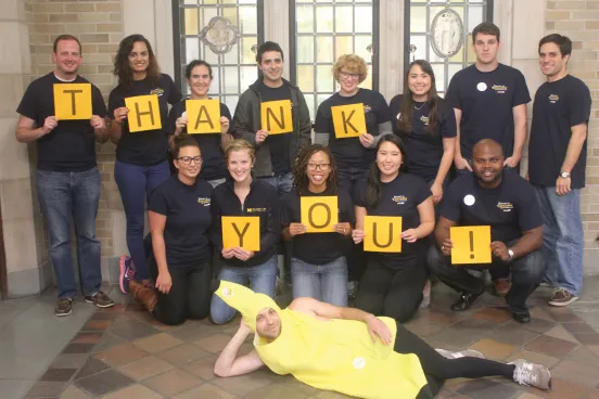 Michigan law student standing with individual letters that spell out: Thank you.